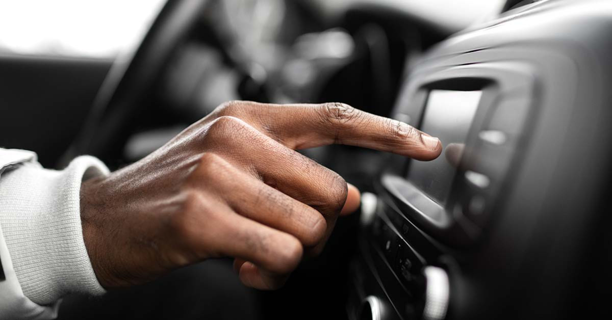 A driver entering a code into their car stereo